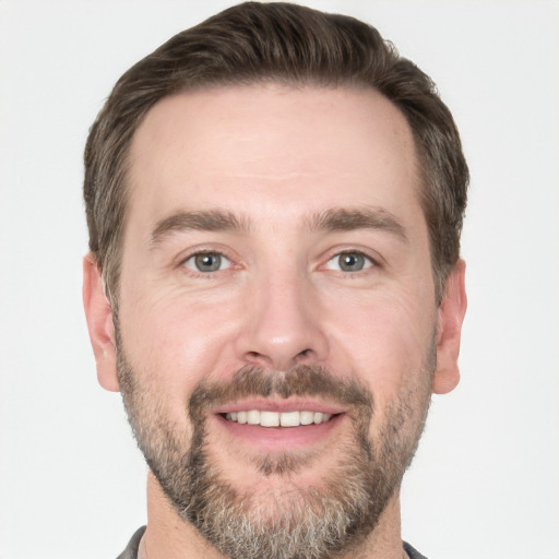 Joyful white adult male with short  brown hair and grey eyes