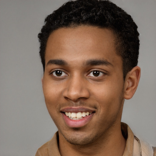 Joyful black young-adult male with short  brown hair and brown eyes