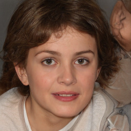 Joyful white child female with medium  brown hair and brown eyes