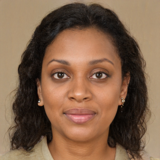 Joyful black young-adult female with medium  brown hair and brown eyes