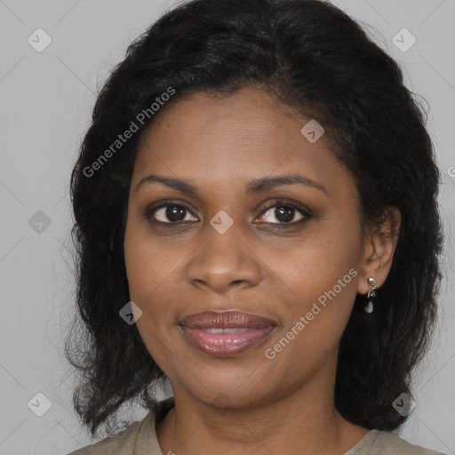 Joyful black young-adult female with long  brown hair and brown eyes