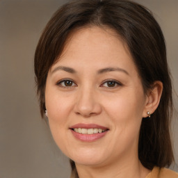 Joyful white adult female with medium  brown hair and brown eyes