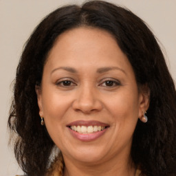 Joyful white adult female with long  brown hair and brown eyes