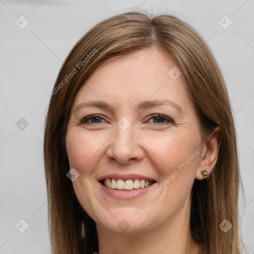 Joyful white adult female with long  brown hair and brown eyes