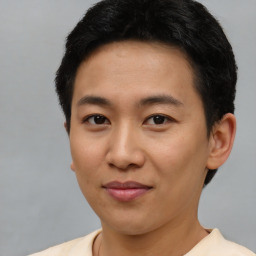 Joyful asian young-adult male with short  brown hair and brown eyes