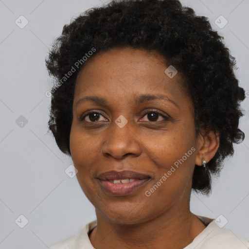 Joyful black adult female with short  black hair and brown eyes