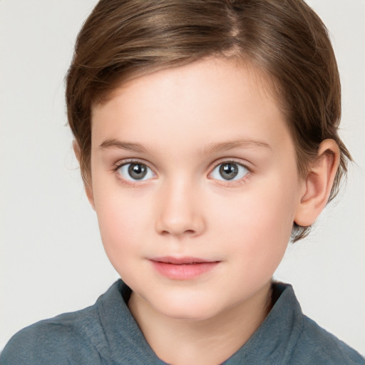 Joyful white child female with short  brown hair and grey eyes