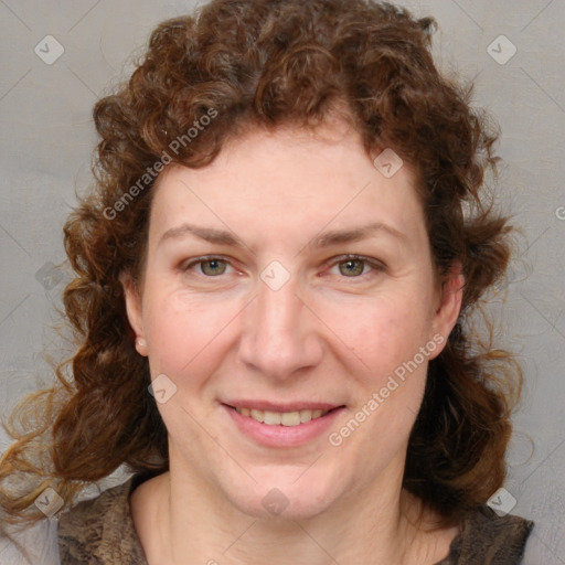 Joyful white adult female with medium  brown hair and blue eyes