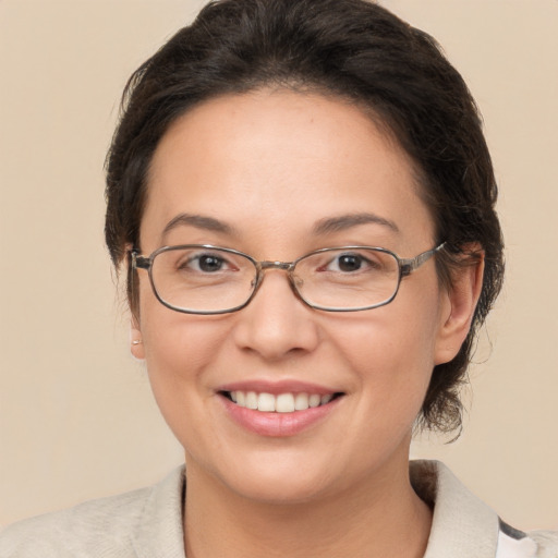 Joyful white adult female with medium  brown hair and brown eyes