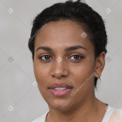 Joyful black young-adult female with short  brown hair and brown eyes