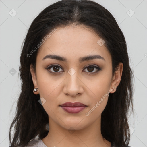 Joyful latino young-adult female with long  brown hair and brown eyes