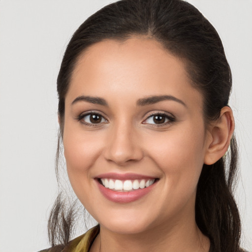 Joyful white young-adult female with long  brown hair and brown eyes