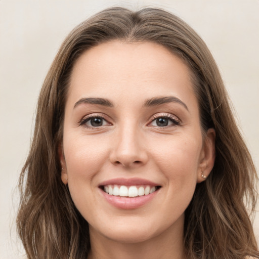 Joyful white young-adult female with long  brown hair and grey eyes