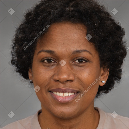 Joyful black adult female with short  brown hair and brown eyes