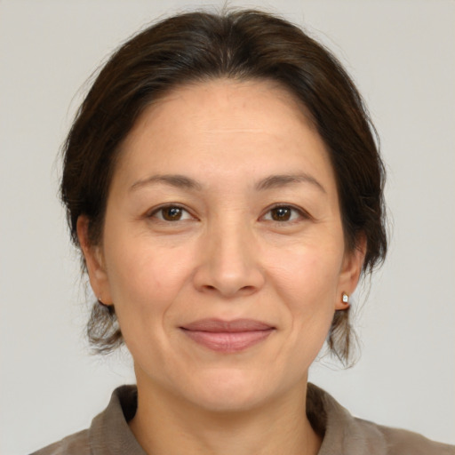 Joyful white adult female with medium  brown hair and brown eyes
