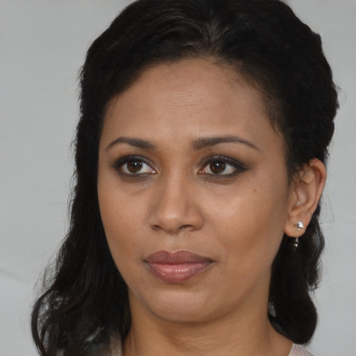 Joyful black young-adult female with medium  brown hair and brown eyes