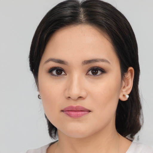 Joyful asian young-adult female with medium  black hair and brown eyes