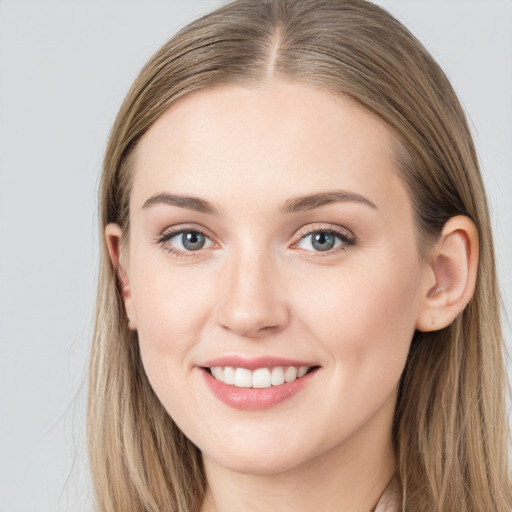 Joyful white young-adult female with long  brown hair and grey eyes