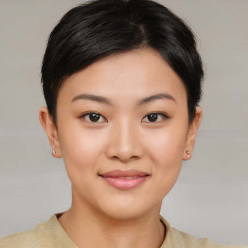 Joyful asian young-adult female with short  brown hair and brown eyes