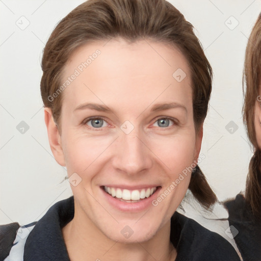 Joyful white young-adult female with medium  brown hair and blue eyes