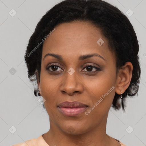 Joyful black adult female with medium  brown hair and brown eyes