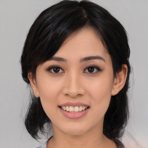 Joyful asian young-adult female with medium  black hair and brown eyes