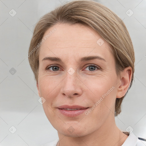 Joyful white adult female with short  brown hair and grey eyes