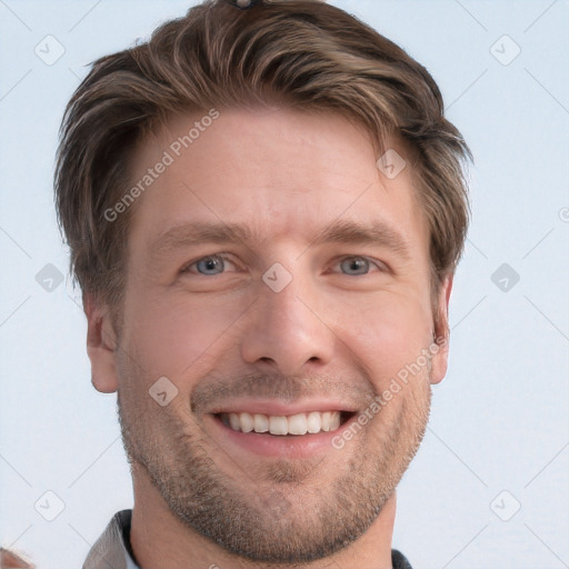 Joyful white young-adult male with short  brown hair and grey eyes