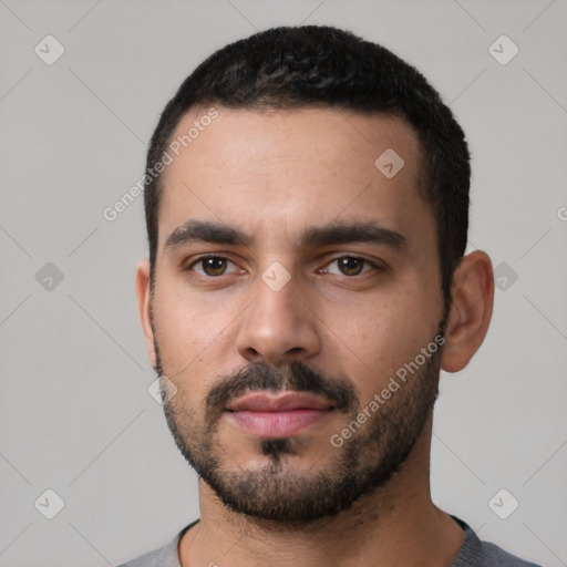 Neutral latino young-adult male with short  black hair and brown eyes