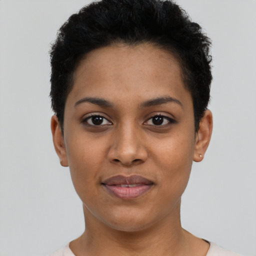 Joyful latino young-adult female with short  black hair and brown eyes
