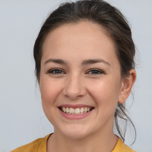 Joyful white young-adult female with medium  brown hair and brown eyes