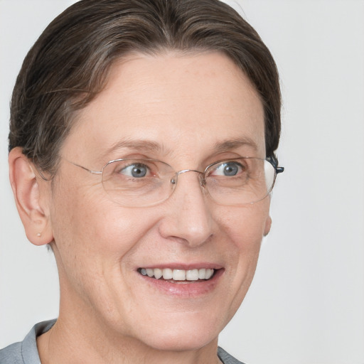 Joyful white adult female with short  brown hair and grey eyes