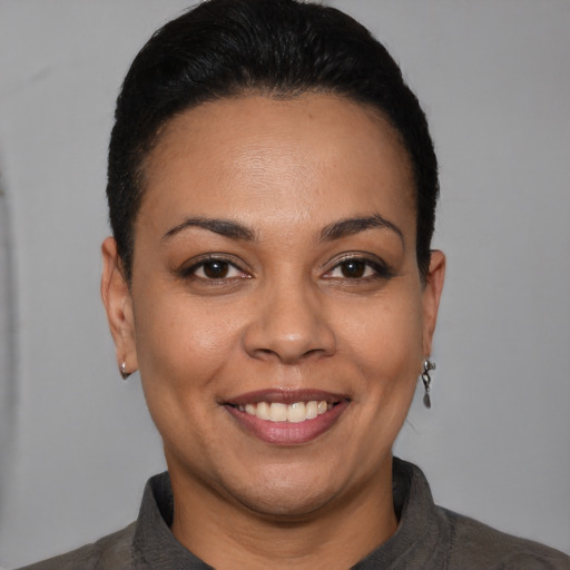 Joyful white young-adult female with short  black hair and brown eyes