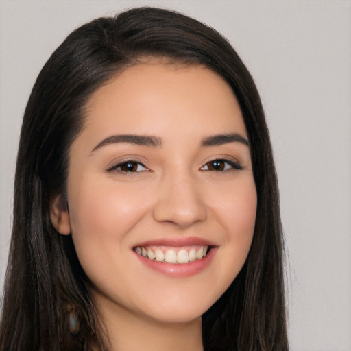 Joyful white young-adult female with long  black hair and brown eyes