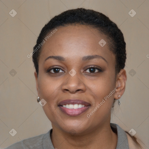 Joyful black young-adult female with short  black hair and brown eyes