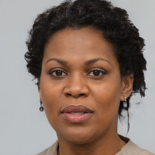 Joyful black adult female with short  black hair and brown eyes