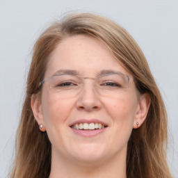 Joyful white adult female with long  brown hair and grey eyes