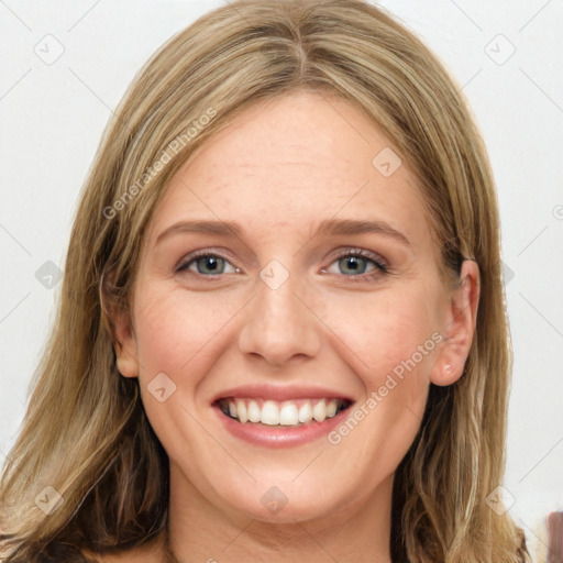 Joyful white young-adult female with long  brown hair and blue eyes