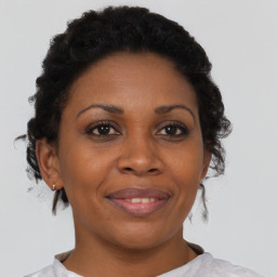 Joyful black adult female with short  brown hair and brown eyes