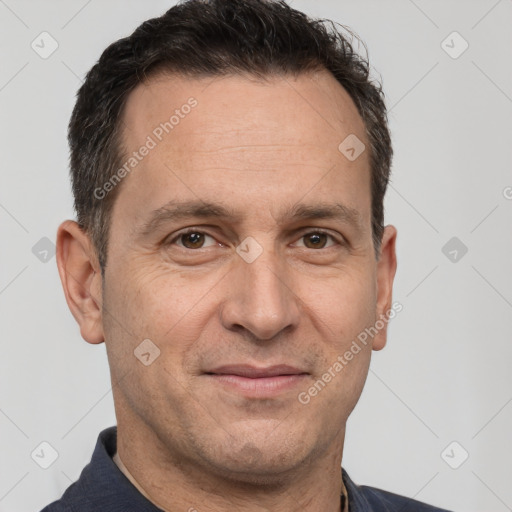 Joyful white adult male with short  brown hair and brown eyes