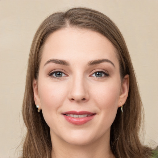 Joyful white young-adult female with long  brown hair and green eyes