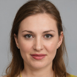 Joyful white young-adult female with medium  brown hair and grey eyes