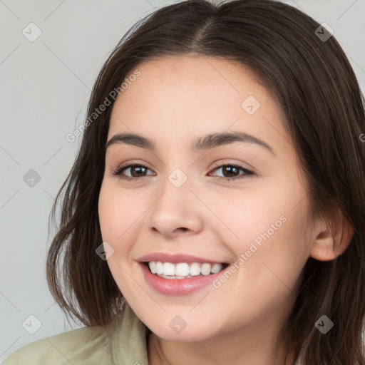 Joyful white young-adult female with long  brown hair and brown eyes