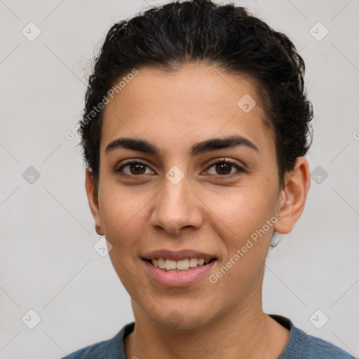 Joyful latino young-adult female with short  black hair and brown eyes