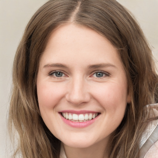 Joyful white young-adult female with long  brown hair and grey eyes