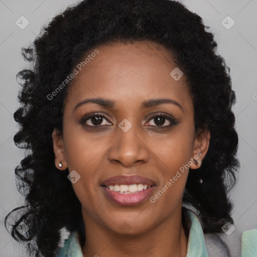 Joyful black young-adult female with long  brown hair and brown eyes