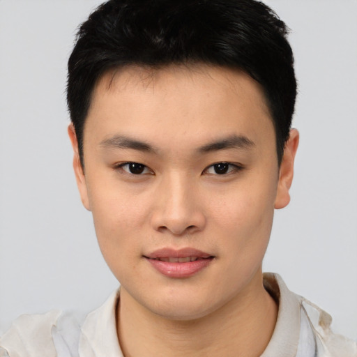 Joyful asian young-adult male with short  black hair and brown eyes