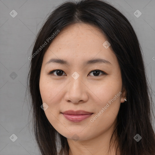 Joyful asian young-adult female with long  brown hair and brown eyes