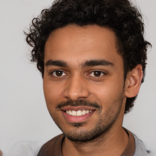 Joyful latino young-adult male with short  brown hair and brown eyes