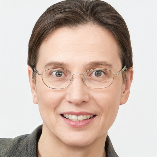 Joyful white adult female with short  brown hair and grey eyes